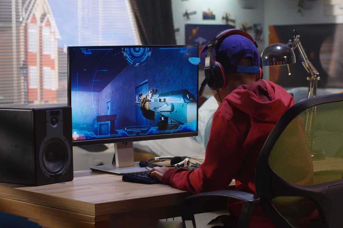 Image of a boy playing a first person shooter video game