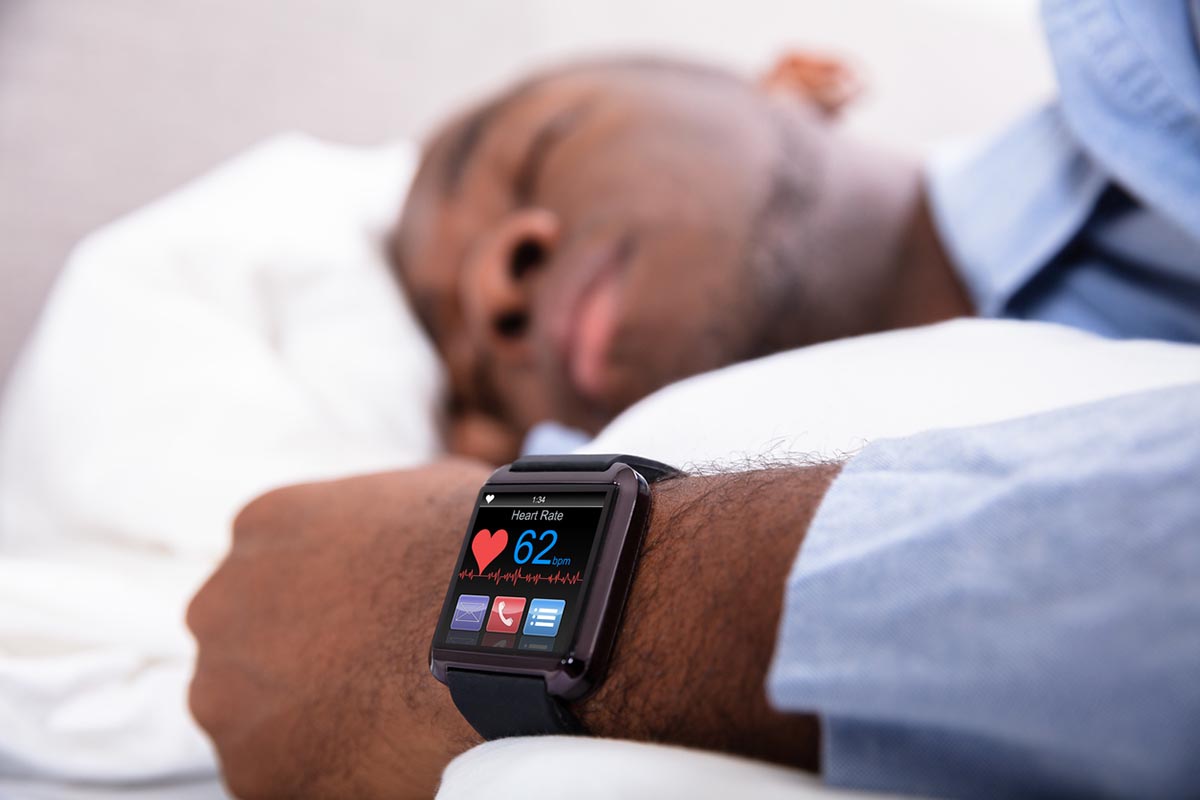 Image of Man Sleeping With Smart Watch Showing Heart Rate